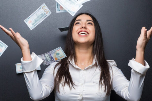 happy-business-woman-money-rain-made-dollars-isolated-black-wall